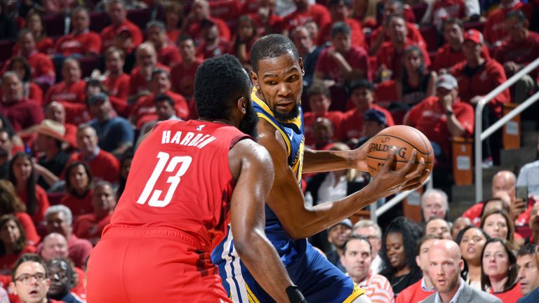 James Harden defends Kevin Durant as he drives to the basket