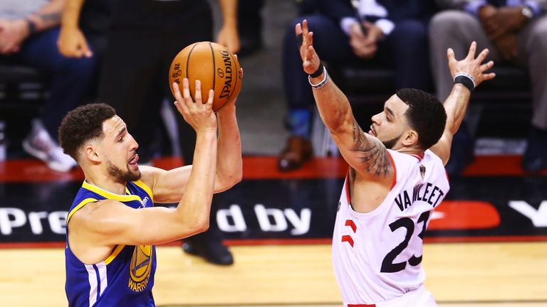 Klay Thompson has Fred VanVleet's hand right in his face as he tries to shoot