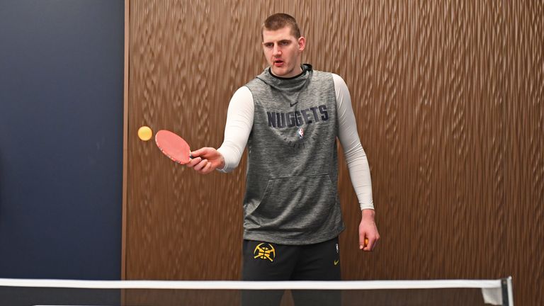 Nikola Jokic plays ping-pong before a Nuggets game
