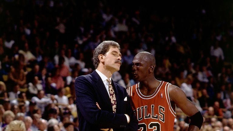 Phil Jackson talks with Michael Jordan during a Chicago Bulls game