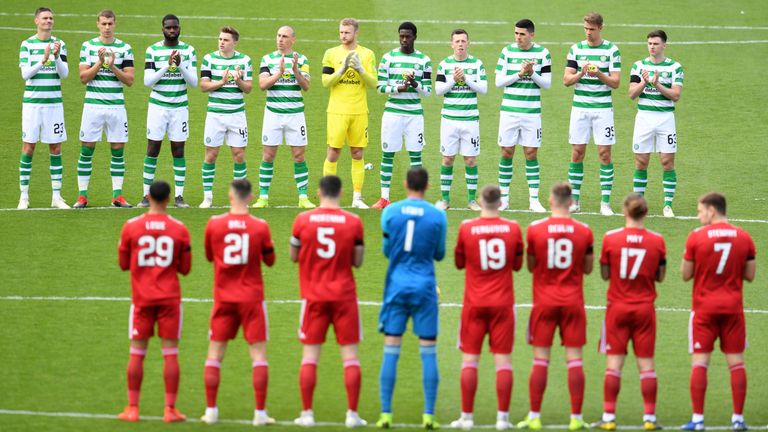 Aberdeen's and Celtic's players observe a minute's applause for Celtic's legendary European Cup winning captain Billy McNeill, who passed away last week. McNeill also managed Aberdeen for a season.