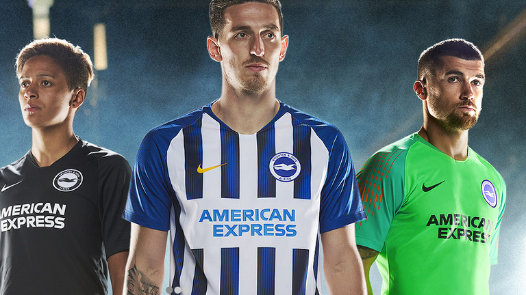 Lewis Dunk models the new Brighton home shirt while the away strip is all back