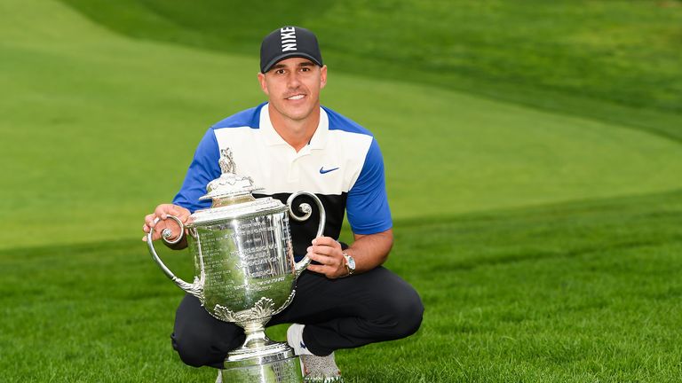 Brooks Koepka proudly displays the Wanamaker Trophy