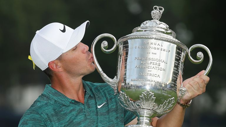 Brooks Koepka of the United States poses with the Wanamaker Trophy on the 18th green after winning the 2018 PGA Championship