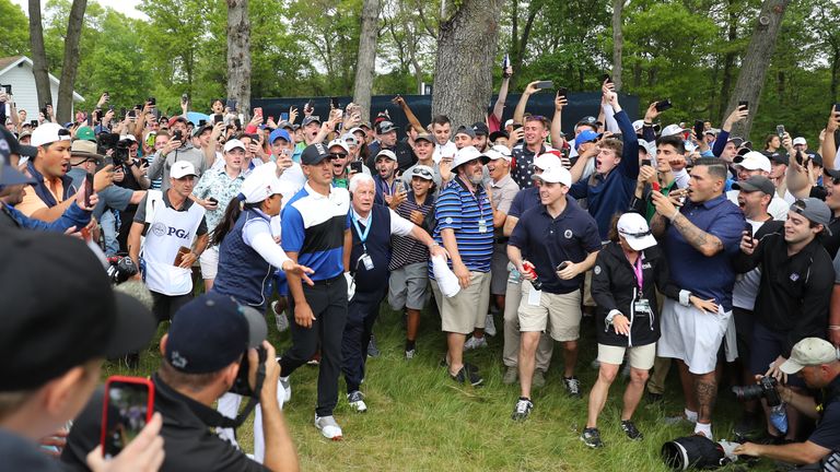 Brooks Koepka braves the New York fans after playing a shot from the rough during the final round of the PGA Championship