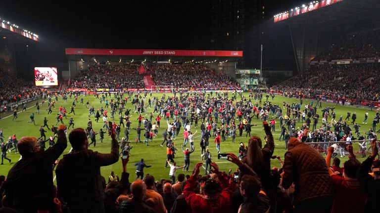 Fans run onto the pitch after Charlton Athletic win the Sky Bet League One Play-off, Second Leg match at The Valley, London.