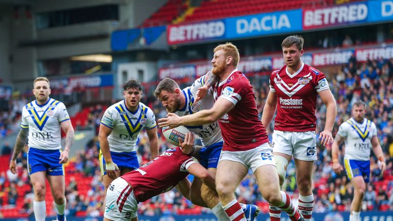 Picture by Alex Whitehead/SWpix.com - 25/05/2019 - Rugby League - Betfred Super League - 2019 Dacia Magic Weekend - Wigan Warriors v Warrington Wolves - Anfield, Liverpool, England - Warrington's Daryl Clark is tackled by Wigan's Joe Bullock and George Williams.