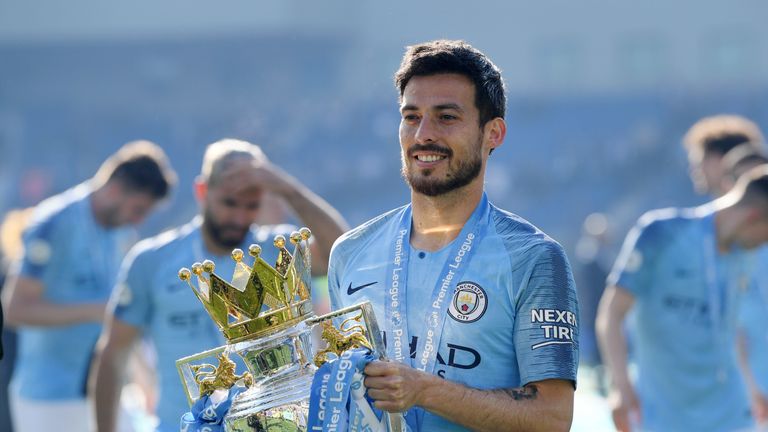 David Silva poses with the Premier League trophy after Manchester City retain the title