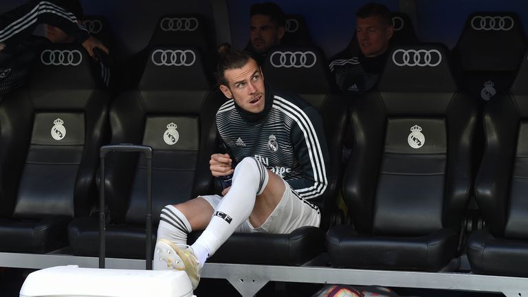 Gareth Bale looks on from the Real Madrid bench prior to a La Liga match against Real Betis at the Santiago Bernabeu Stadium