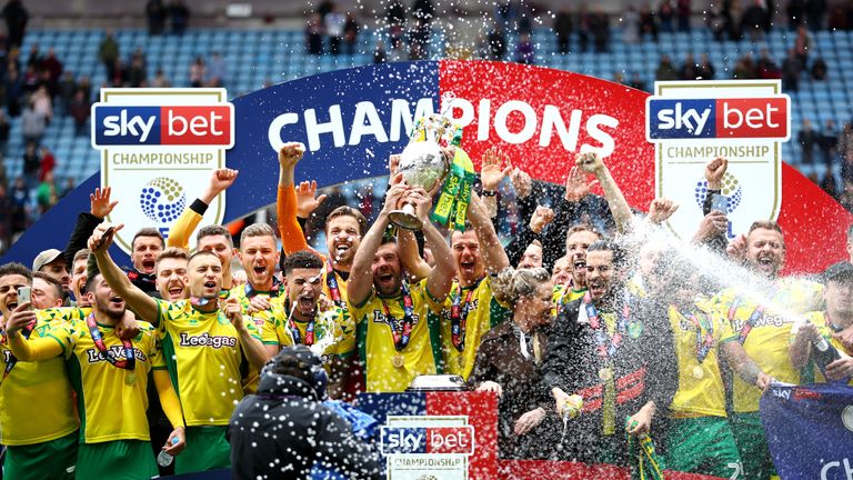 Captain Grant Hanley lifts the Sky Bet EFL Championship trophy as Norwich City are crowned champions