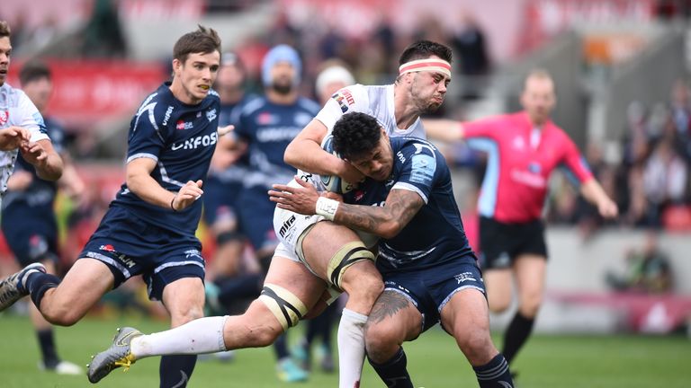 Gloucester's Jake Polledti of Gloucester is tackled by Sale's Denny Solomona