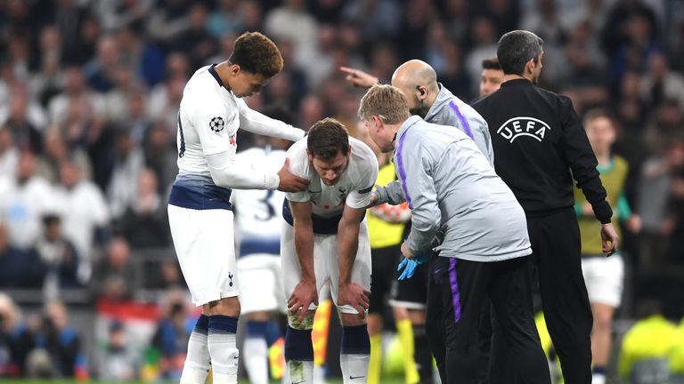 Jan Vertonghen receives attention at the side of the pitch following a clash of heads with his own team-mate