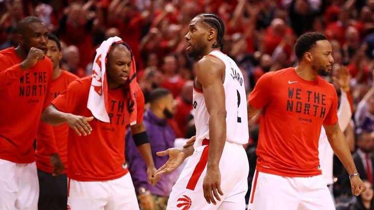 Kawhi Leonard of the Toronto Raptors celebrates with teammates on the bench during overtime against the Milwaukee Bucks in game three of the NBA Eastern Conference Finals
