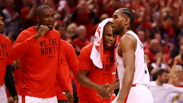 Kawhi Leonard #2 of the Toronto Raptors celebrates with teammates on the bench during overtime against the Milwaukee Bucks in game three of the NBA Eastern Conference Finals at Scotiabank Arena on May 19, 2019 in Toronto, Canada.