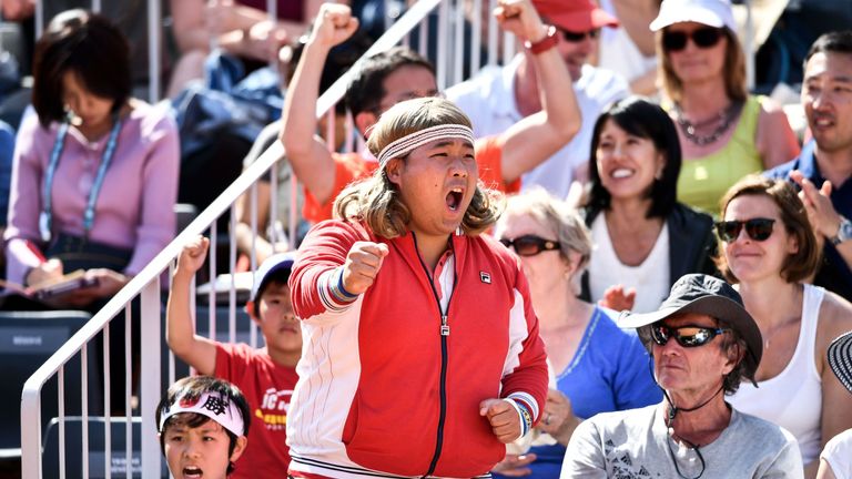 A dressed-up supporter cheers during the men's singles third round match between Japan's Kei Nishikori and Serbia's Laslo Djere on day six of The Roland Garros 2019 French Open tennis tournament in Paris on May 31, 2019.