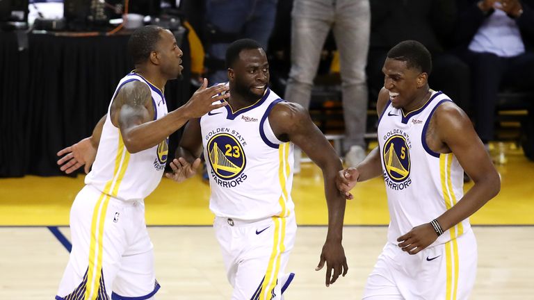 Draymond Green #23 of the Golden State Warriors celebrates with Andre Iguodala #9 and Kevon Looney #5 during the second half against the Portland Trail Blazers in game one of the NBA Western Conference Finals at ORACLE Arena on May 14, 2019 in Oakland, California. 