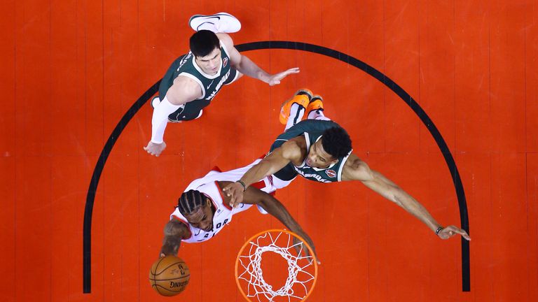 Kawhi Leonard of the Toronto Raptors shoots the ball against Giannis Antetokounmpo of the Milwaukee Bucks during the first half in game three of the NBA Eastern Conference Finals