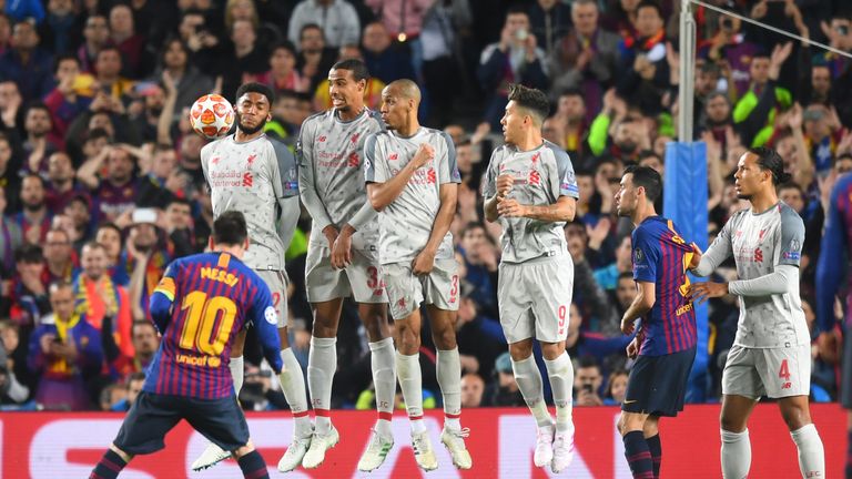 Liverpool players look on as Barcelona's Lionel Messi takes a free-kick during the Champions League semi-final at the Nou Camp