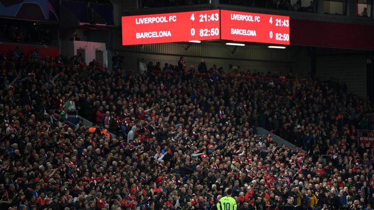 Lionel Messi stands with hands on hips as the overhead scoreboard displays Liverpool 4 - 0 Barcelona