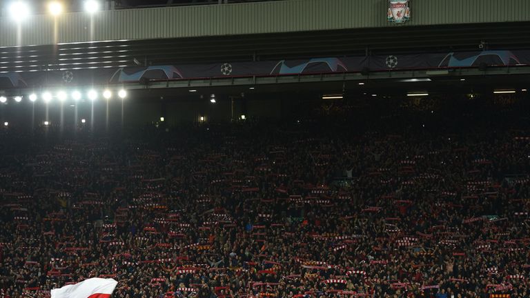 Liverpool players and staff line up in front of the Kop at the full time
