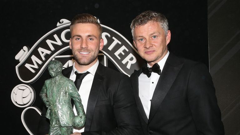 Luke Shaw is presented with the Sir Matt Busby Fans' Player of the Year award by Ole Gunnar Solskjaer