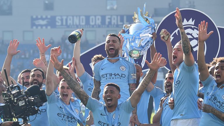 Manchester City players celebrate after winning the Premier League title
