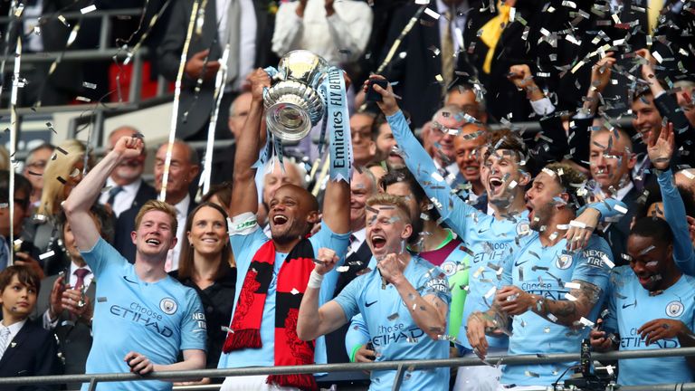 Manchester City captain Vincent Kompany lifts the FA Cup