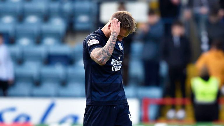 Martin Woods cannot hide his despondency as he leaves the pitch as Dundee's relegation is confirmed