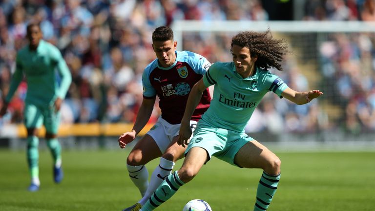 Matteo Guendouzi turns with the ball under pressure from Ashley Westwood