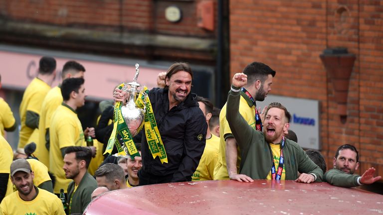 Norwich City manager Daniel Farke (centre) with the trophy during the promotion parade in Norwich City Centre.