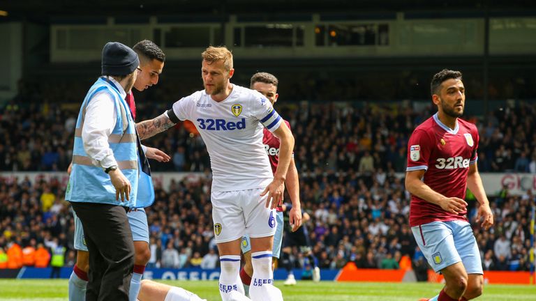 Leeds United's Patrick Bamford clutches his faces following an altercation with Aston Villa winger Anwar El Ghazi