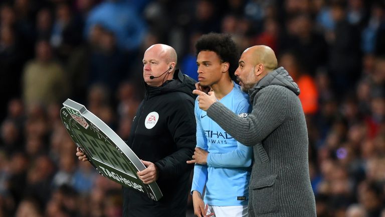 Pep Guardiola talks to substitute Leroy Sane during the Premier League match vs Leicester City at the Etihad Stadium