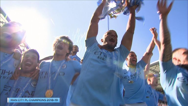 Manchester City lift the Premier League trophy.