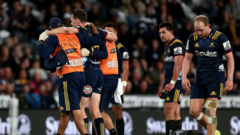 Highlanders full-back Ben Smith is helped from the pitch after suffering a hamstring strain