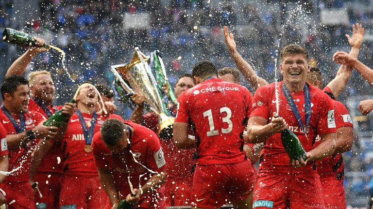 Saracens' players celebrate with champagne after winning a third Heineken Champions Cup title in four years