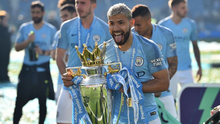 Sergio Aguero poses for a photo holding the Premier League trophy