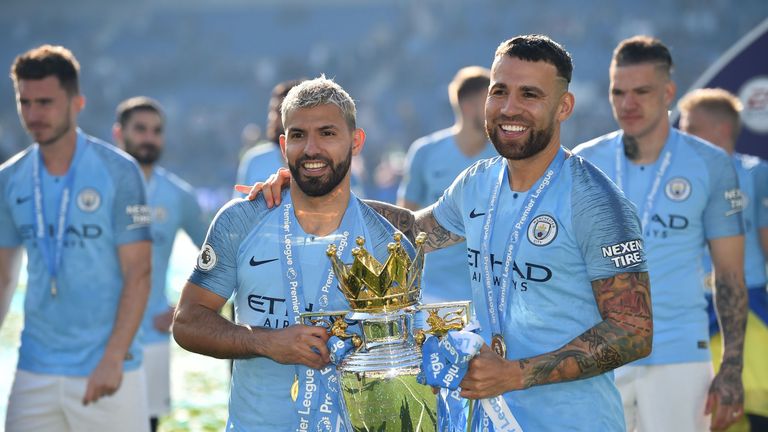 Sergio Aguero and Nicolas Otamendi celebrate with the Premier League trophy