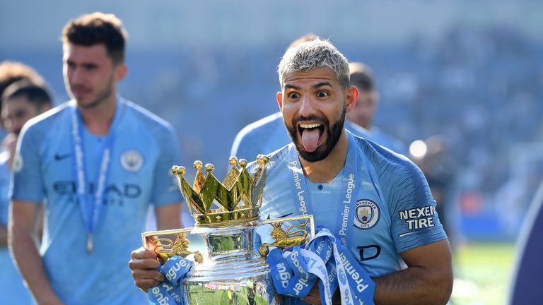 Sergio Aguero celebrates with the Premier League trophy after winning the title with a 4-1 victory over Brighton