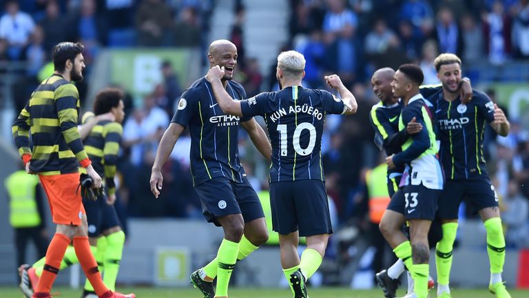 Sergio Aguero and Vincent Kompany celebrate after Manchester City retain the Premier League title with a 4-1 win over Brighton