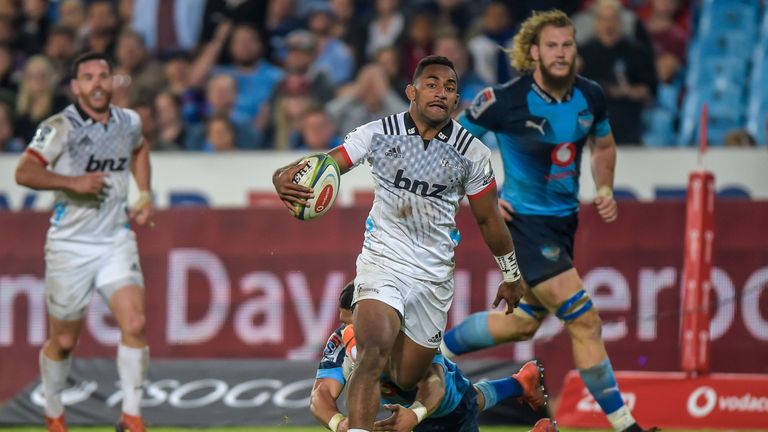 The Crusaders' hat-trick hero Sevu Reece slips through a tackle