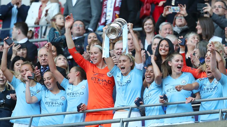 Steph Houghton of Manchester City Women lifts the Women's FA Cup Trophy 