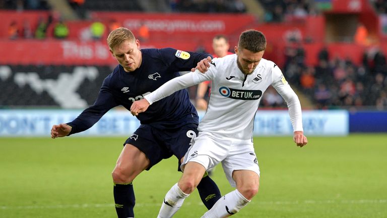 Martyn Waghorn and Matt Grimes battle for the ball