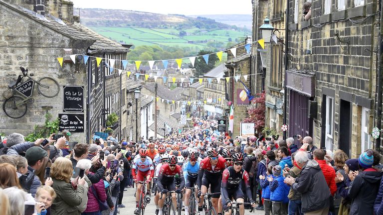 Team INEOS lead the peloton including leader Lawless as they climb a hill in Haworth