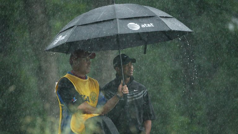 Tiger Woods shelters from the rain during the 2009 US Open