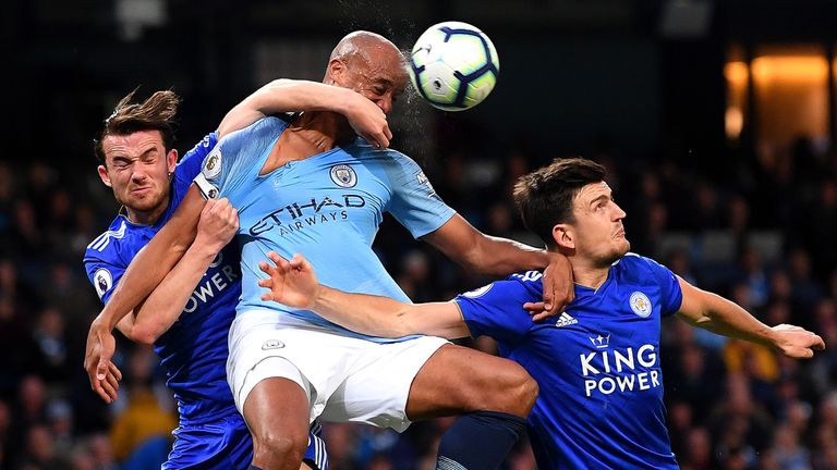 Vincent Kompany battles for possession with Ben Chilwell and Harry Maguire