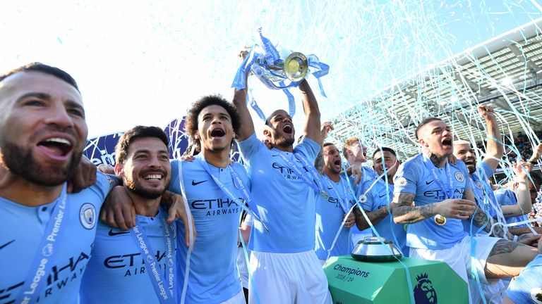 Vincent Kompany lifts the Premier League trophy after winning the title with a 4-1 victory over Brighton