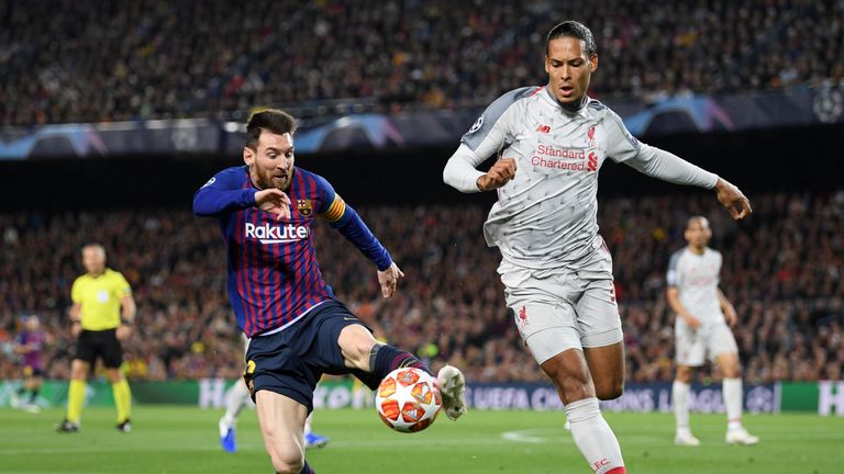 Liverpool's Virgil van Dijk challenges Lionel Messi for the ball at the Nou Camp