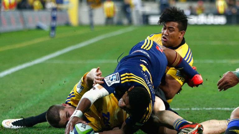 Waisake Naholo of the Highlanders scores a try despite the tackles of Dane Coles and Julian Savea of the Hurricanes during the Super Rugby Final match between the Hurricanes and the Highlanders at Westpac Stadium on July 4, 2015 in Wellington, New Zealand.