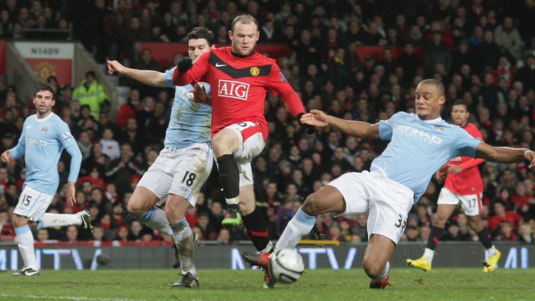 Wayne Rooney of Manchester United clashes with Vincent Kompany of Manchester City during the Carling Cup Semi-Final Second Leg match between Manchester United and Manchester City at Old Trafford on January 27 2010, in Manchester, England.