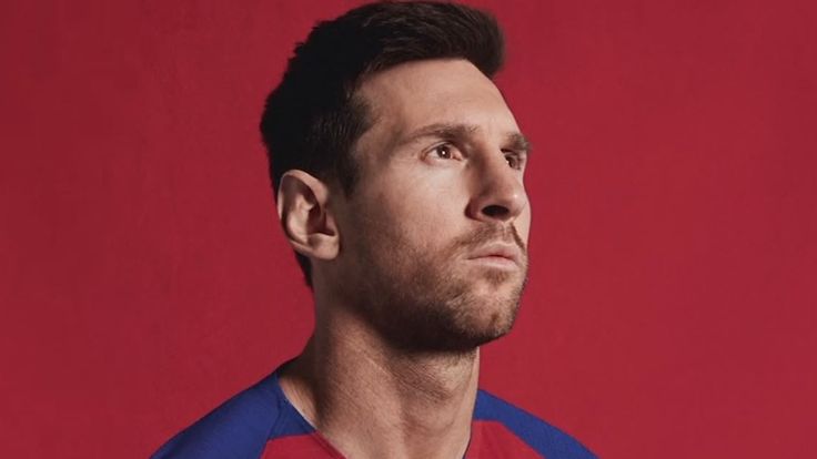Lionel Messi models Barcelona's new checkerboard kit